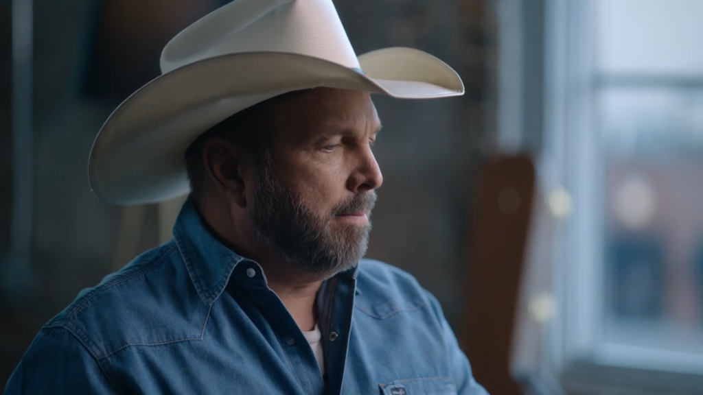 Garth Brooks wears a hat, viewed from the side.