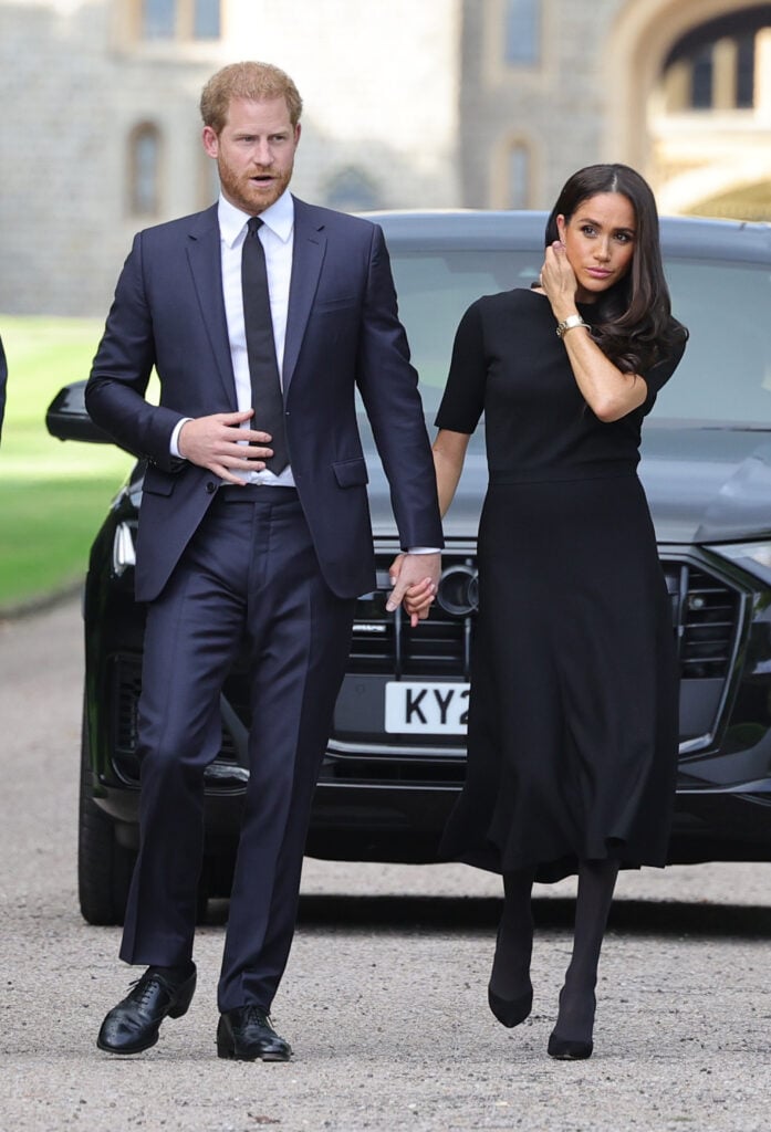 Prince Harry, Duke of Sussex, and Meghan, Duchess of Sussex arrive on the long Walk at Windsor Castle arrive to view flowers and tributes to HM Queen Elizabeth on September 10, 2022 in Windsor, England.  