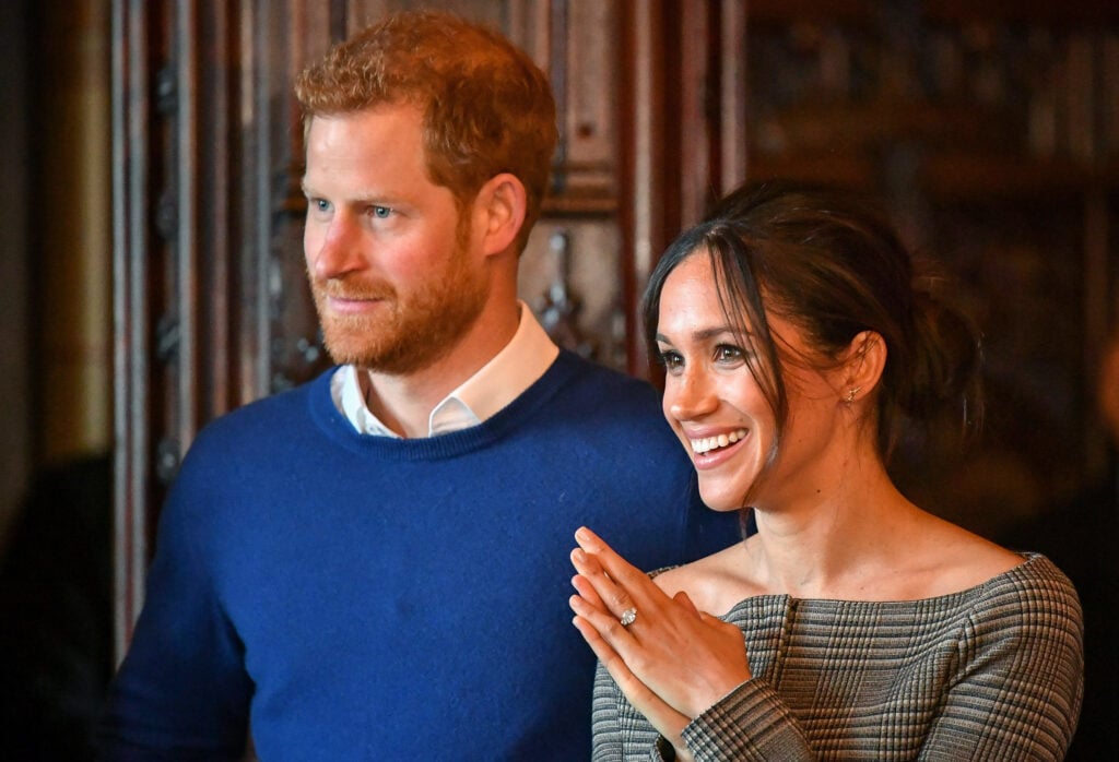 Prince Harry and Meghan Markle watch a performance by a Welsh choir in the banqueting hall during a visit to Cardiff Castle on January 18, 2018 in Cardiff, Wales.