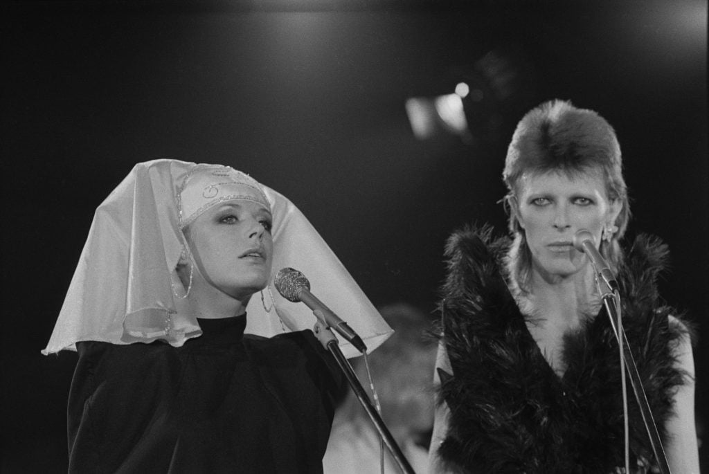British singer and actress Marianne Faithfull on stage with David Bowie (1947 - 2016) at a live recording of 'The 1980 Floor Show' for the NBC 'Midnight Special' TV show.