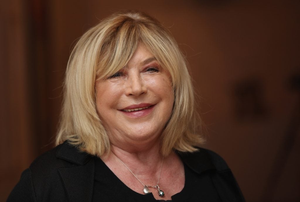 Singer-songwriter Marianne Faithfull poses next to artworks as she opens the Innocence And Experience exhibition at Tate Liverpool on April 20, 2012 in Liverpool, England.