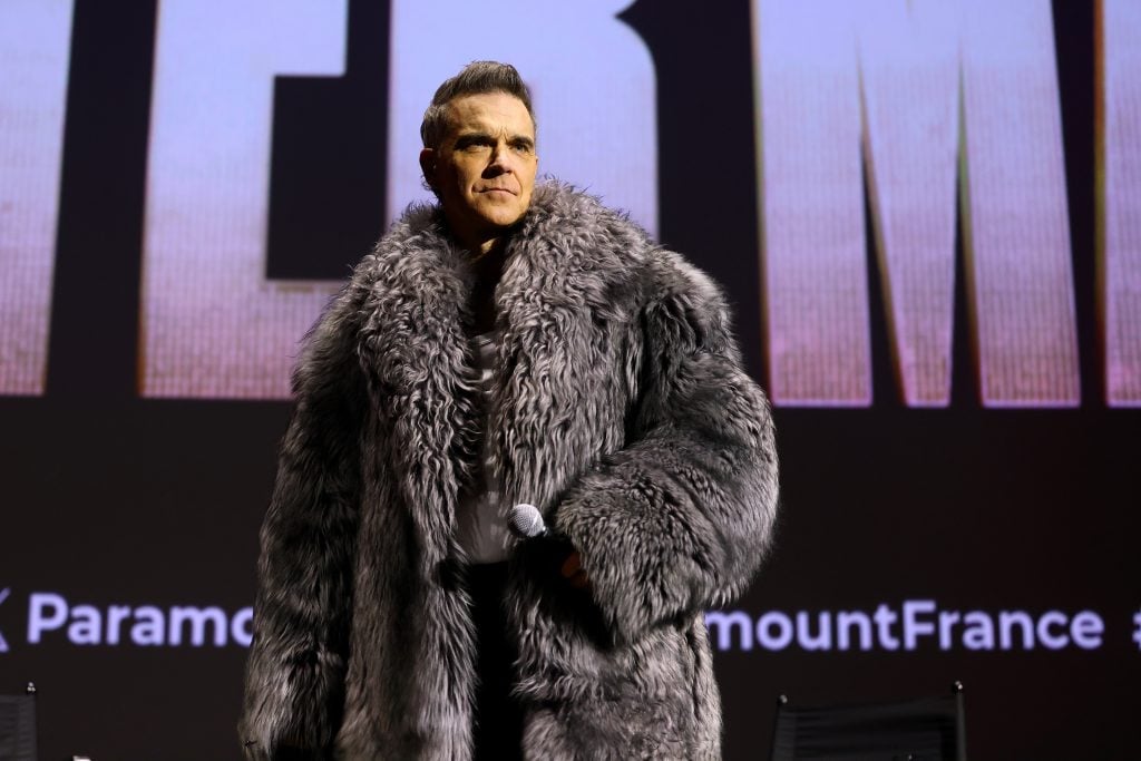 Robbie Williams speaks on stage during the "Better Man" special screening at Le Grand Rex on December 13, 2024 in Paris, France.