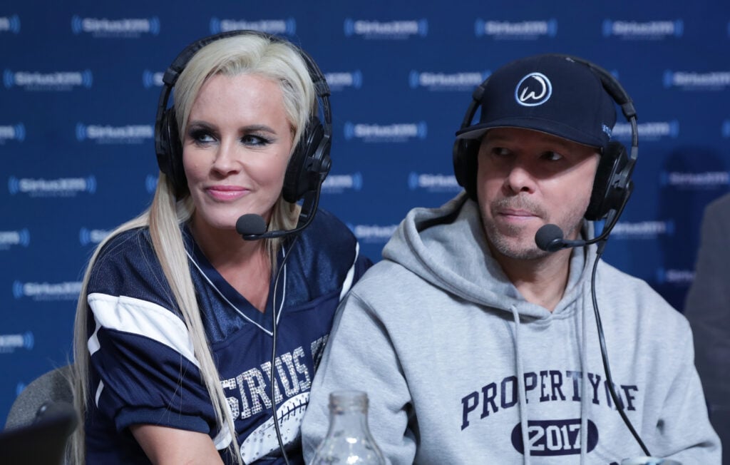 Jenny McCarthy, left, hosts a special edition of her SiriusXM show, The Jenny McCarthy Show, live from the SiriusXM set with Donnie Wahlberg at Super Bowl LI Radio Row at the George R. Brown Convention Center on February 3, 2017 in Houston, Texas.