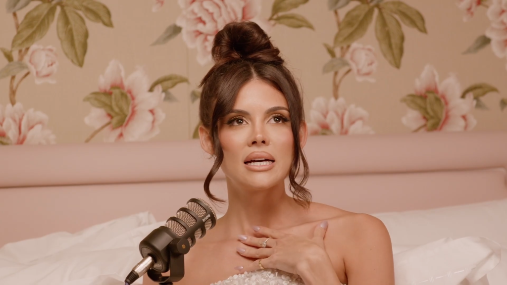 Holly Scarfone in bed on her podcast.