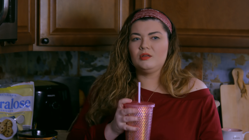 Amber Portwood holds a drink cup in her kitchen.