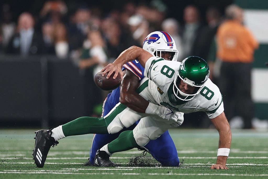 Quarterback Aaron Rodgers #8 of the New York Jets sacked by defensive end Leonard Floyd #56 of the Buffalo Bills during the first quarter of the NFL game at MetLife Stadium on September 11, 2023 in East Rutherford, New Jersey.