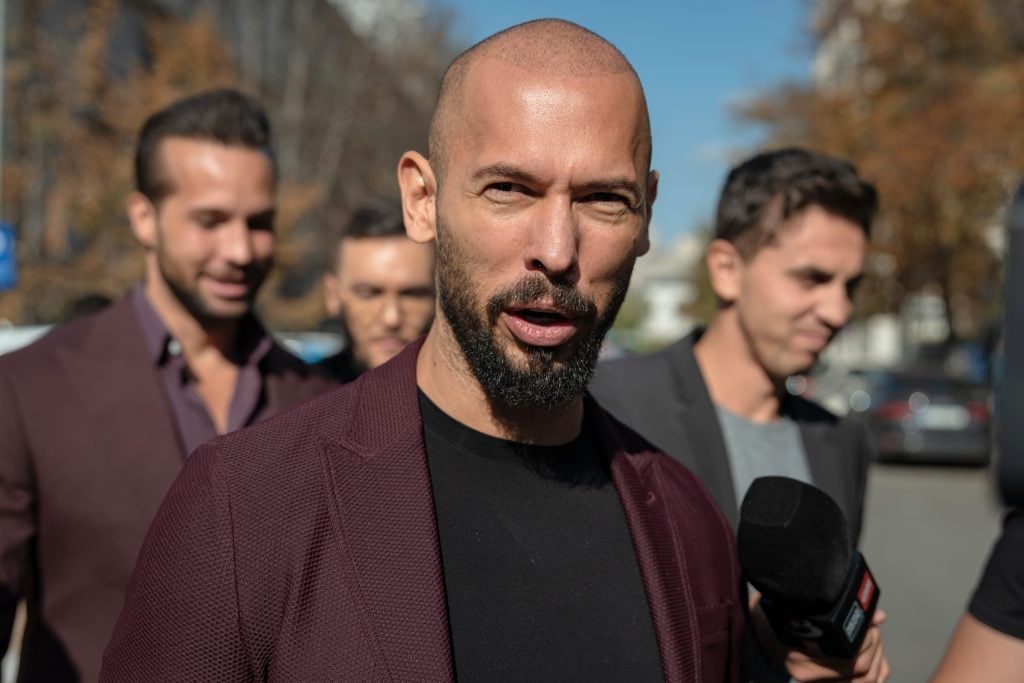 Andrew Tate talks to the media outside the Court of Appeal on October 15, 2024 in Bucharest, Romania. Social Media Influencer Andrew Tate and his brother Tristan are appearing in court to appeal a decision to proceed with their trial on charges of rape, human trafficking and forming a criminal gang to exploit women.