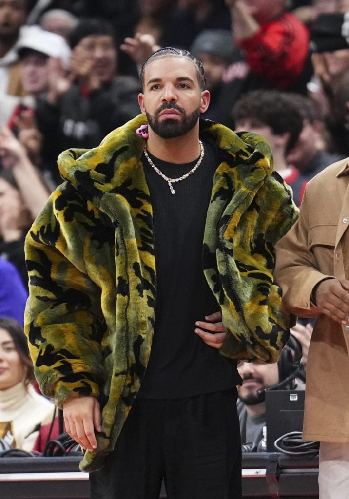 Drake watches on as the Sacramento Kings play the Toronto Raptors during the second half of their basketball game at the Scotiabank Arena on November 2, 2024 in Toronto, Ontario, Canada. 