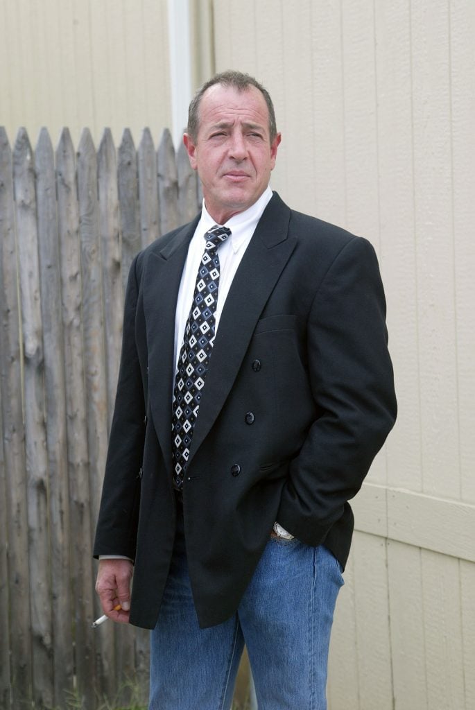 Michael Lohan smoking, because of course he is, in August 2010.