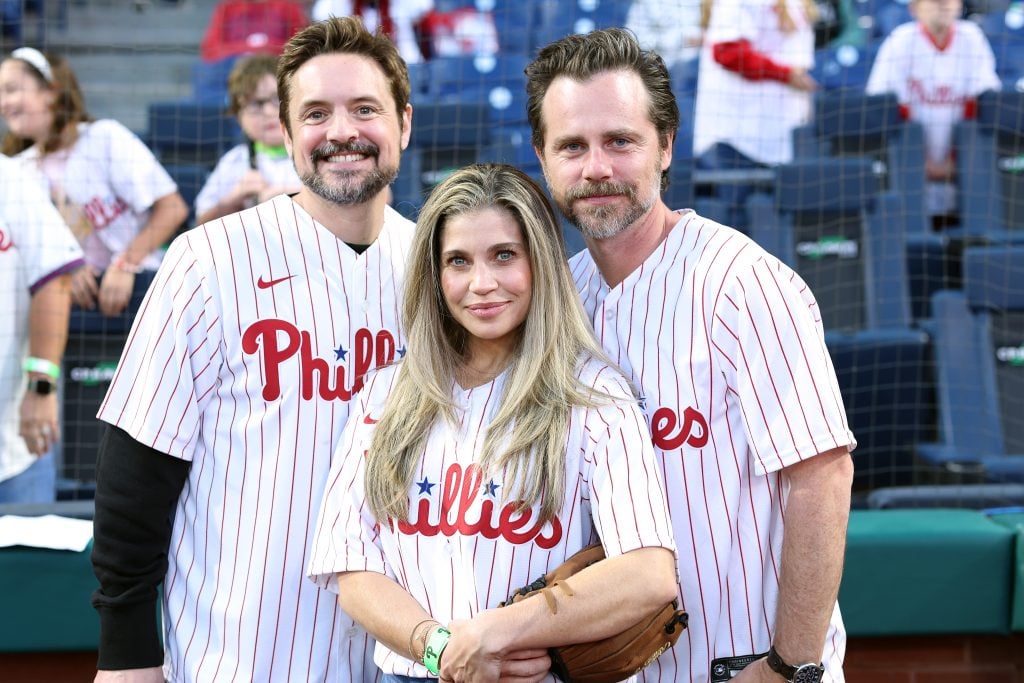 Actors Will Friedle, Danielle Fishel and Rider Strong pose for a photo during a game between the Philadelphia Phillies and the Pittsburgh Pirates at Citizens Bank Park on September 27, 2023 in Philadelphia, Pennsylvania.