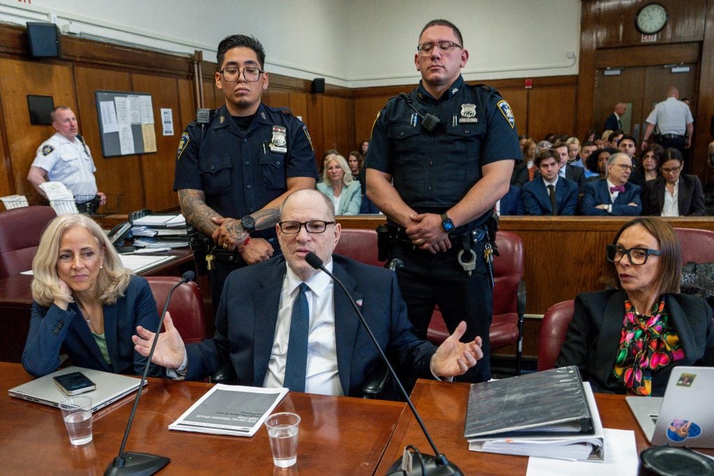 Disgraced Hollywood film producer Harvey Weinstein gestures as he appears in Manhattan Criminal Court ahead of opening arguments in the rape and sexual assault trial against him in New York City on April 23, 2025.