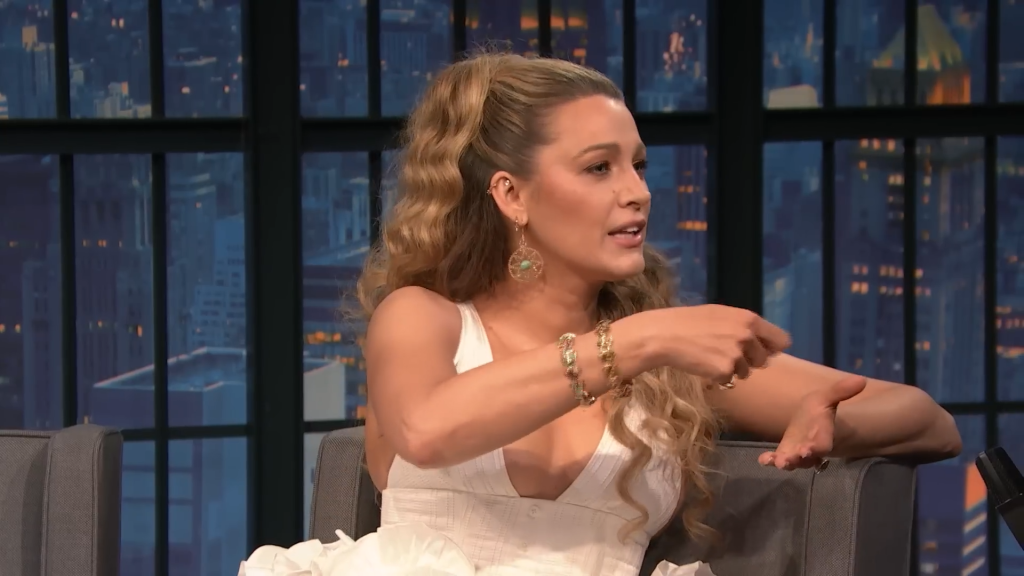 Blake Lively mimes adding parmesan cheese to her food.