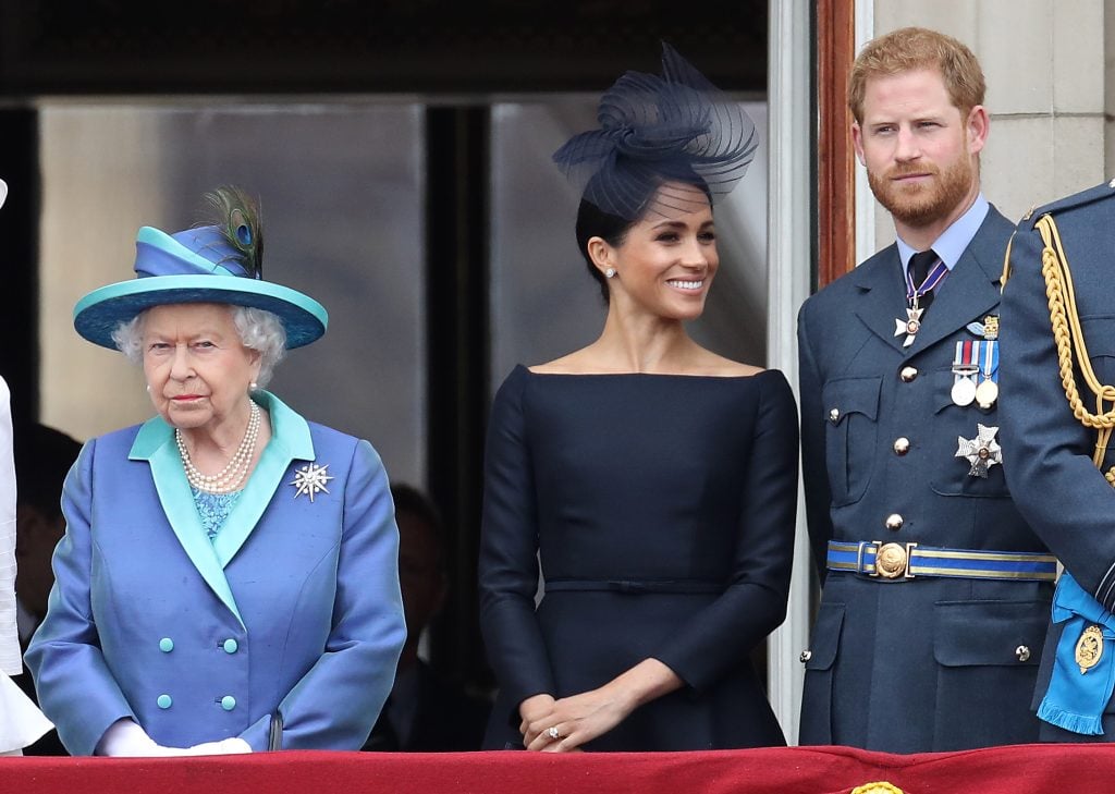 Queen Elizabeth II, Prince Harry, Duke of Sussex and Meghan, Duchess of Sussex on the balcony of Buckingham Palace as the Royal family attend events to mark the Centenary of the RAF on July 10, 2018 in London, England.