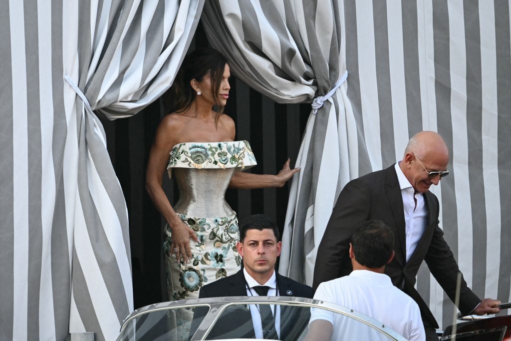 Amazon founder Jeff Bezos and Lauren Sanchez get on a taxi boat at the Aman Hotel in Venice on June 26, 2025. Celebrities in superyachts sail into Venice this week for the three-day wedding party of Amazon tycoon Jeff Bezos and Lauren Sanchez, despite irate locals who say the UNESCO city is no billionaire's playground. 